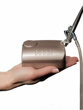 Dinair Airbrush compressor in champagne and gun